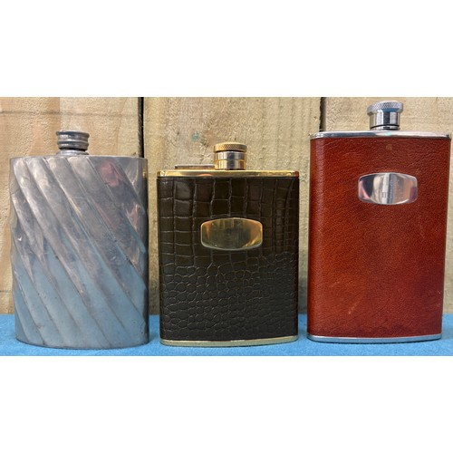 190 - A Collection of vintage whisky flasks.