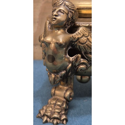 284 - Antique heavy brass ink well pot; Lid designed with an eagle finial. Body detailed with three cherub... 