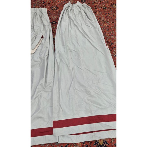 329 - Two pairs of Large double lined curtains. 275cm drop. Comes with four tie backs. Grey ground and red... 