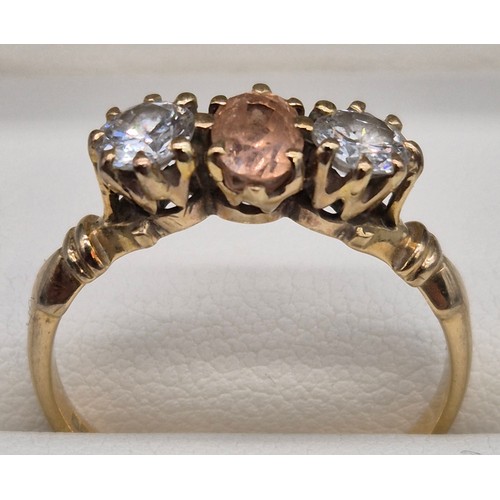 81 - 18ct yellow gold Padparadscha Sapphire and Diamond three stone ring. Central claw set, oval faceted ... 