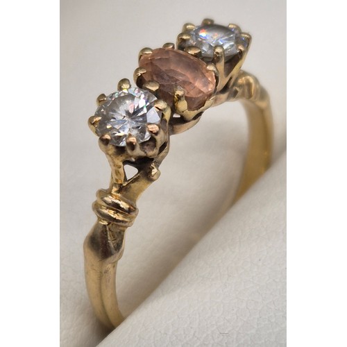 81 - 18ct yellow gold Padparadscha Sapphire and Diamond three stone ring. Central claw set, oval faceted ... 