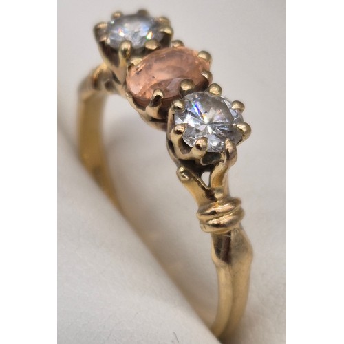81 - 18ct yellow gold Padparadscha Sapphire and Diamond three stone ring. Central claw set, oval faceted ... 