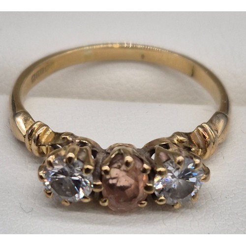 81 - 18ct yellow gold Padparadscha Sapphire and Diamond three stone ring. Central claw set, oval faceted ... 