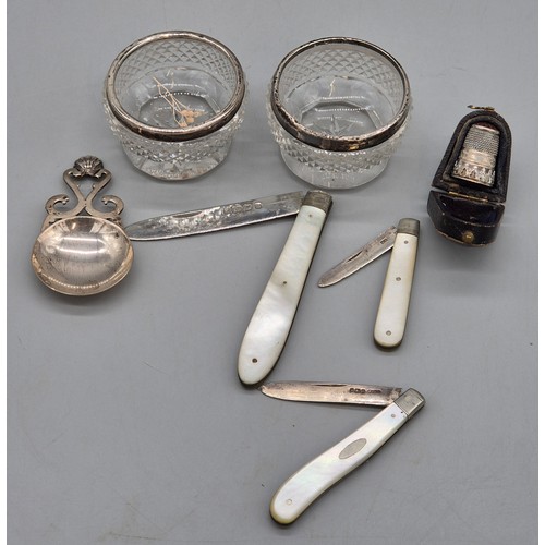 79 - A Selection of silver items; Three silver and mother of pearl fruit knives. Edinburgh silver tea cad... 