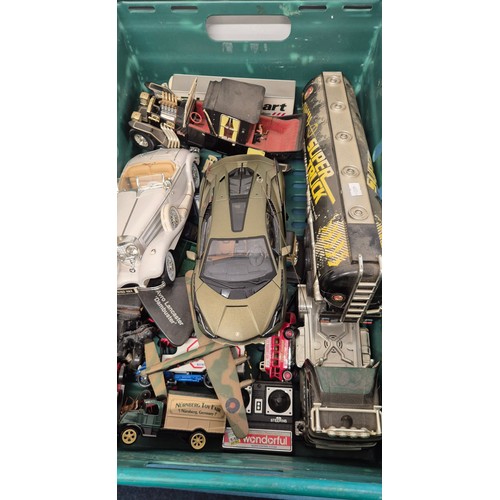 135 - Two crates of model vehicles; boxed Dinky model, Ghost Busters boxed model, Maisto and Volvo collect... 
