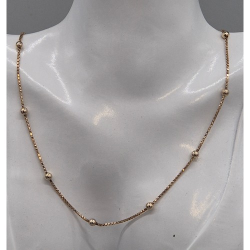6 - 9ct yellow gold necklace fitted with white gold spheres. 5.14grams. 40cm length.