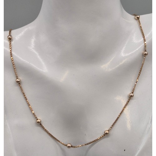 6 - 9ct yellow gold necklace fitted with white gold spheres. 5.14grams. 40cm length.