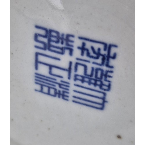 173 - Antique Chinese raised relief dragon pattern vase with reign mark to base on a wood carved stand.