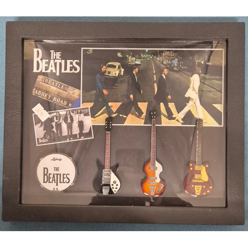 199 - Selection of The Beatles collectables; Framed miniature replicas of guitars and drum, brick fragment... 