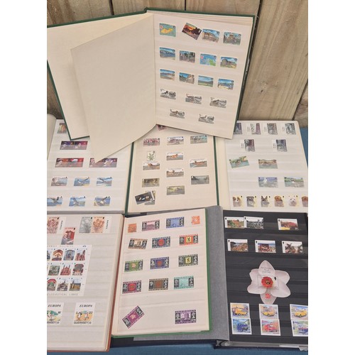226 - Tray of seven stamp albums containing Guernsey stamps.