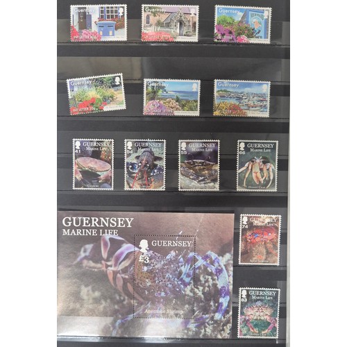 226 - Tray of seven stamp albums containing Guernsey stamps.