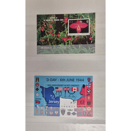 227 - Tray of seven stamp albums containing Jersey stamps.