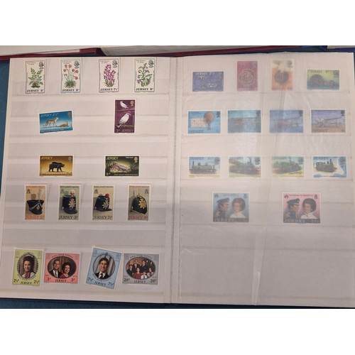 227 - Tray of seven stamp albums containing Jersey stamps.