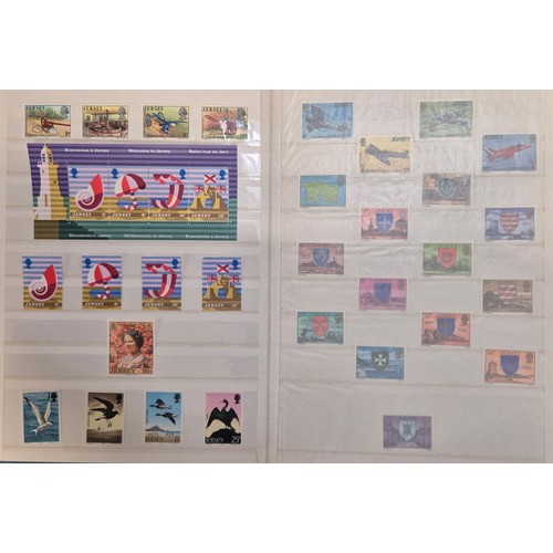 227 - Tray of seven stamp albums containing Jersey stamps.