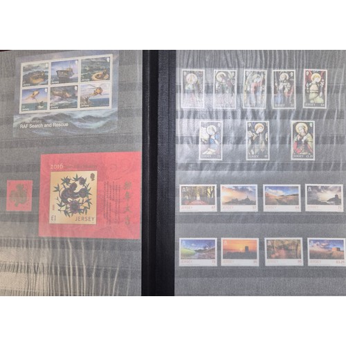 227 - Tray of seven stamp albums containing Jersey stamps.