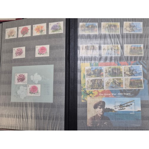 227 - Tray of seven stamp albums containing Jersey stamps.