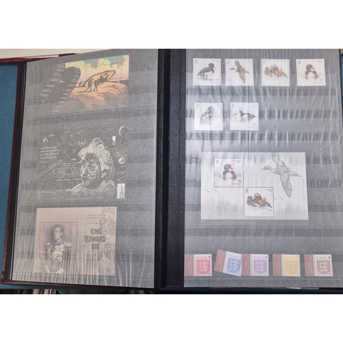 227 - Tray of seven stamp albums containing Jersey stamps.