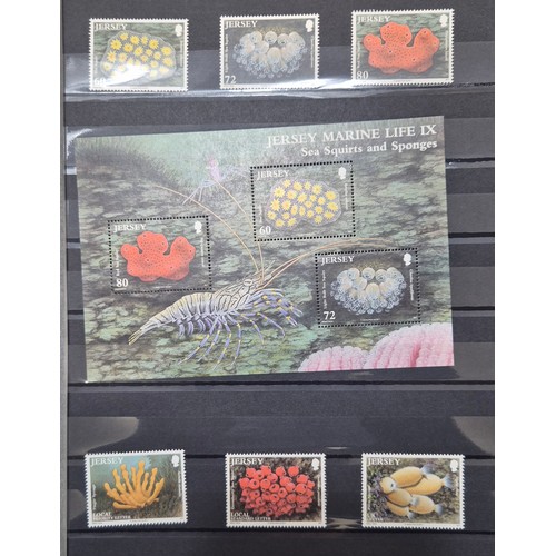 227 - Tray of seven stamp albums containing Jersey stamps.