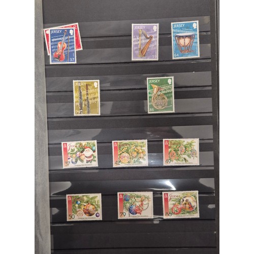 227 - Tray of seven stamp albums containing Jersey stamps.