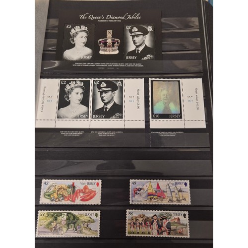 227 - Tray of seven stamp albums containing Jersey stamps.