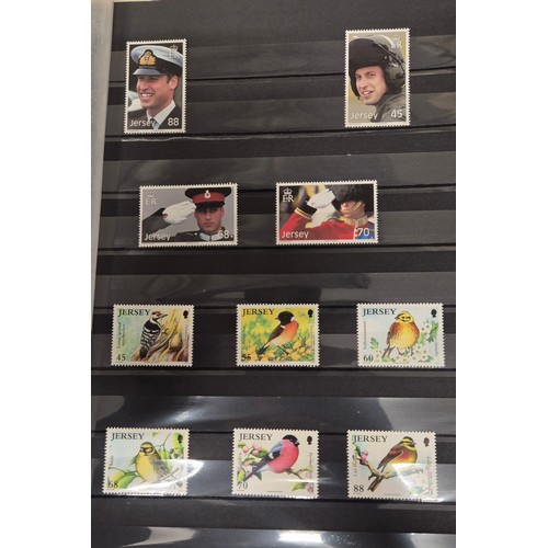 227 - Tray of seven stamp albums containing Jersey stamps.