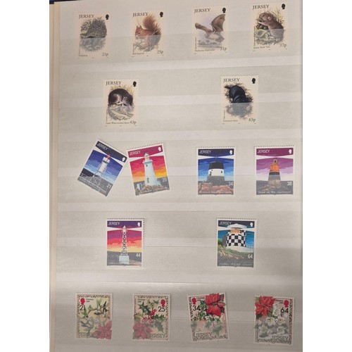 227 - Tray of seven stamp albums containing Jersey stamps.