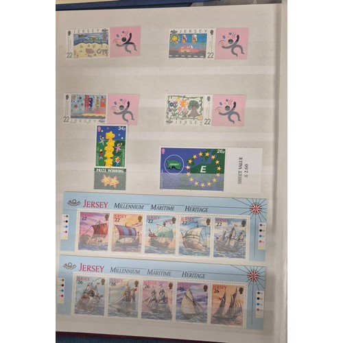 227 - Tray of seven stamp albums containing Jersey stamps.