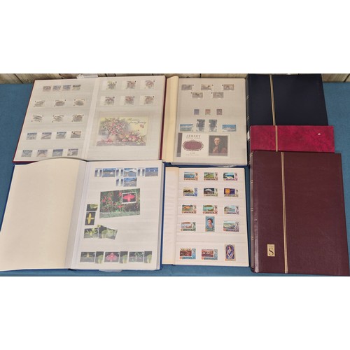 227 - Tray of seven stamp albums containing Jersey stamps.