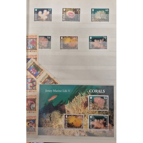 227 - Tray of seven stamp albums containing Jersey stamps.