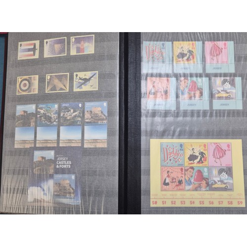 227 - Tray of seven stamp albums containing Jersey stamps.