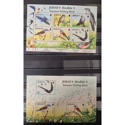 227 - Tray of seven stamp albums containing Jersey stamps.