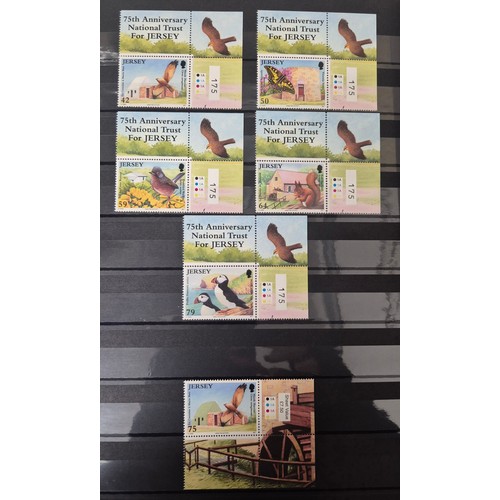 227 - Tray of seven stamp albums containing Jersey stamps.