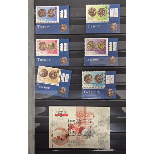 227 - Tray of seven stamp albums containing Jersey stamps.