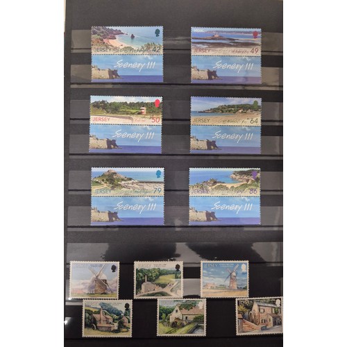 227 - Tray of seven stamp albums containing Jersey stamps.