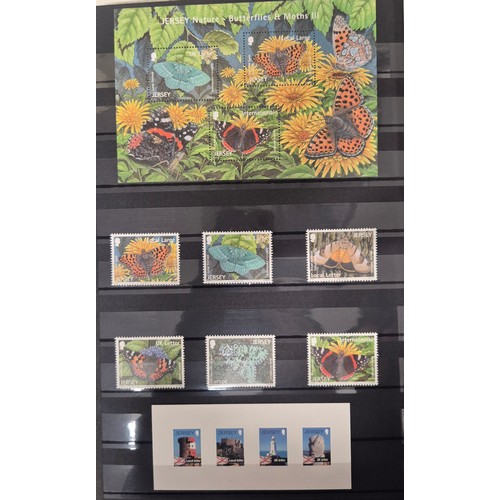 227 - Tray of seven stamp albums containing Jersey stamps.