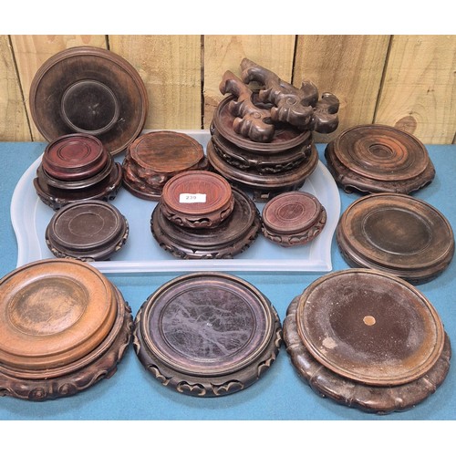 239 - Two trays of 19th and 20th century Chinese carved wooden stands.
