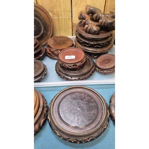 239 - Two trays of 19th and 20th century Chinese carved wooden stands.