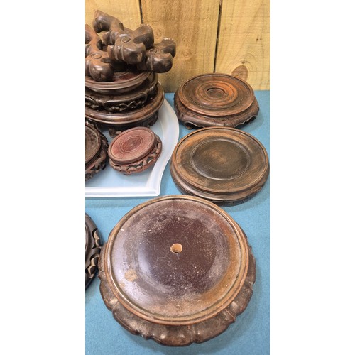 239 - Two trays of 19th and 20th century Chinese carved wooden stands.