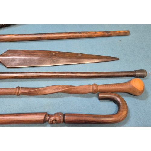 243 - Selection of African carved items; four African hand carved walking sticks, Zulu style shield and ca... 