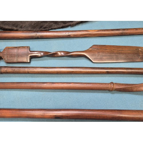 243 - Selection of African carved items; four African hand carved walking sticks, Zulu style shield and ca... 