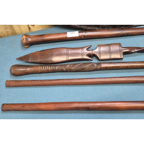243 - Selection of African carved items; four African hand carved walking sticks, Zulu style shield and ca... 