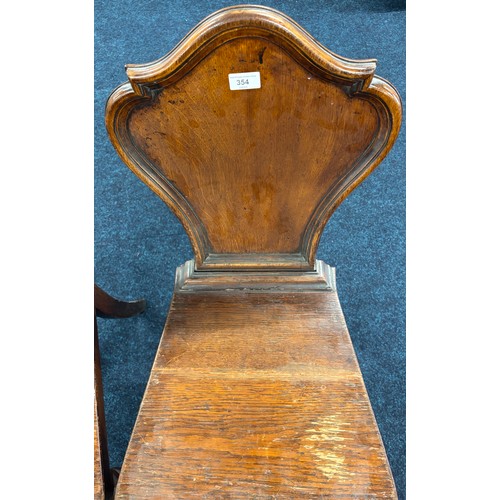 354 - John Taylor of Edinburgh
Two Victorian hall chairs with shield back and raised on turned legs. 91cm ... 