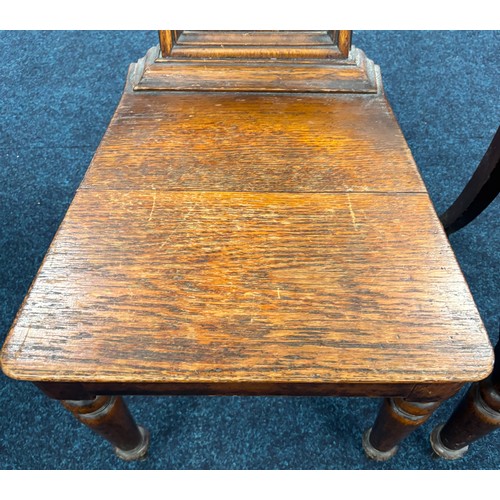 354 - John Taylor of Edinburgh
Two Victorian hall chairs with shield back and raised on turned legs. 91cm ... 