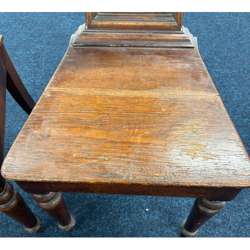 354 - John Taylor of Edinburgh
Two Victorian hall chairs with shield back and raised on turned legs. 91cm ... 