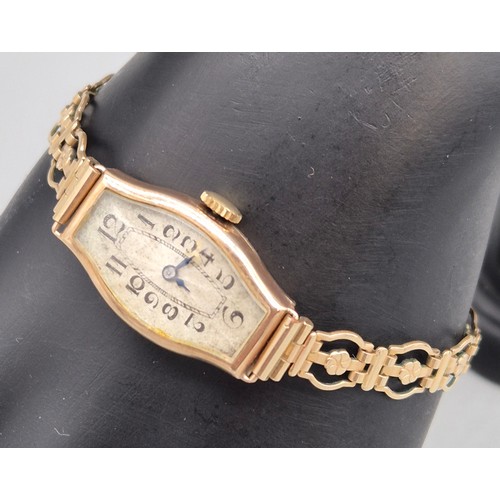 60 - 9ct yellow gold art deco design watch. Fitted with a rolled gold bracelet strap. Non runner.