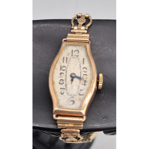 60 - 9ct yellow gold art deco design watch. Fitted with a rolled gold bracelet strap. Non runner.
