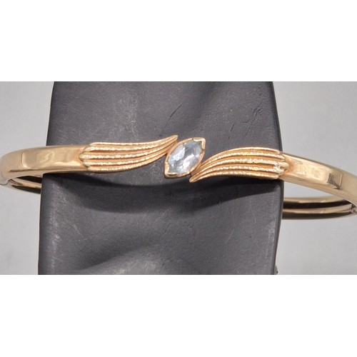 51 - 9ct yellow gold bangle fitted with a blue quartz gem stone. 9.86grams.
