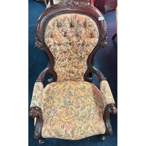 437 - Reproduction of a 19th century parlour arm chair. Button back. Dark wood frame and floral material.