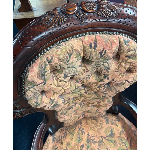 437 - Reproduction of a 19th century parlour arm chair. Button back. Dark wood frame and floral material.