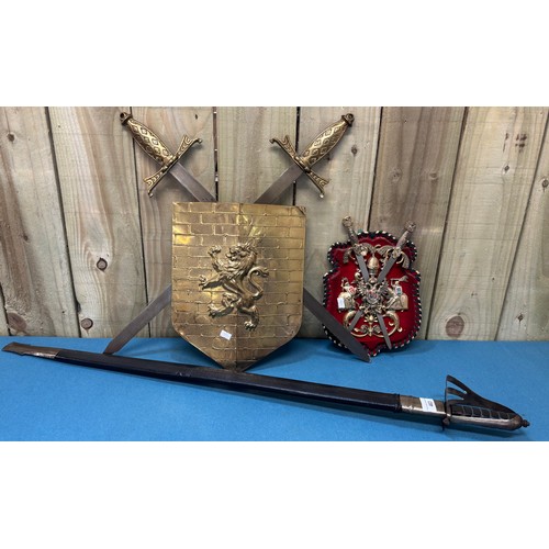 463 - Indian Sabre and scabbard. Together with two wall hanging shield and sword plaques.